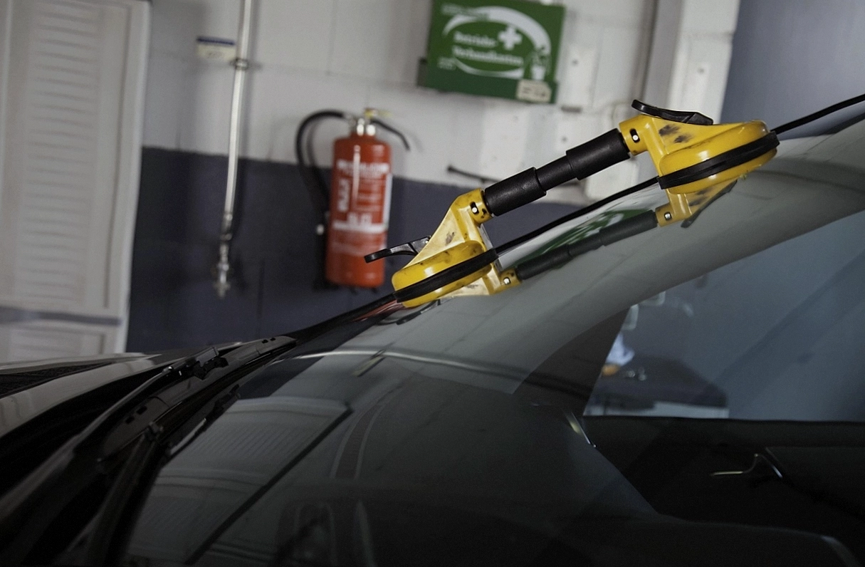 Mechanic draining engine oil during a scheduled service